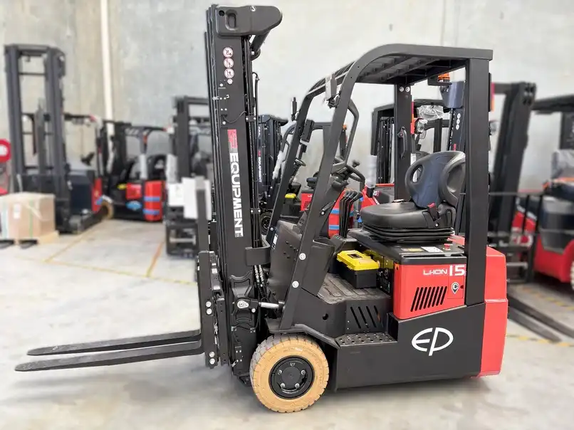 Thumbnail of EP Equipment CPD15TVL 1.5T three-wheel lithium-ion forklift in warehouse, highlighting compact design and agile movement between racks
