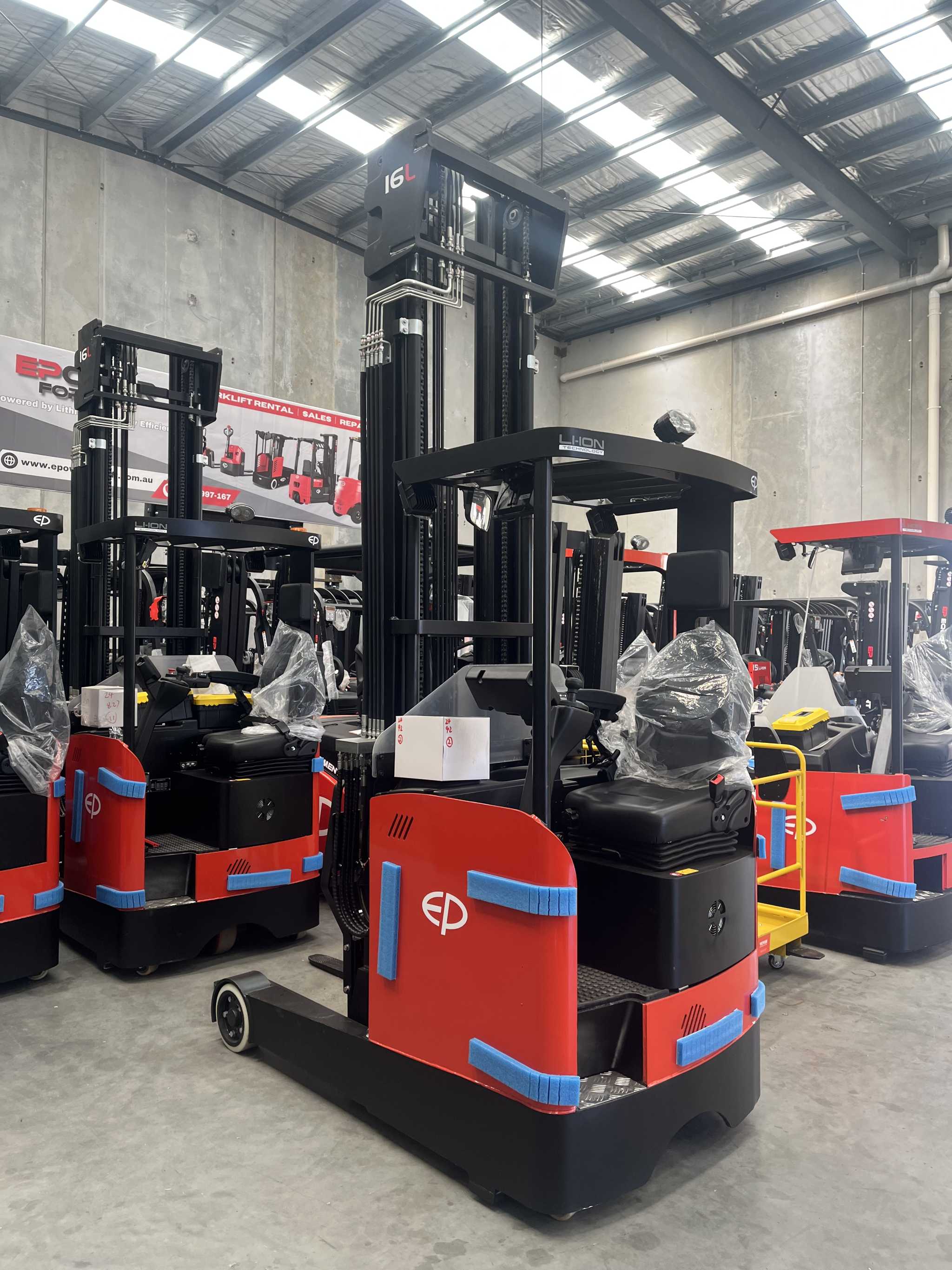 Thumbnail of Photo of CQD16L 1.6T lithium-ion electric reach truck by EP Equipment stopping in warehouse