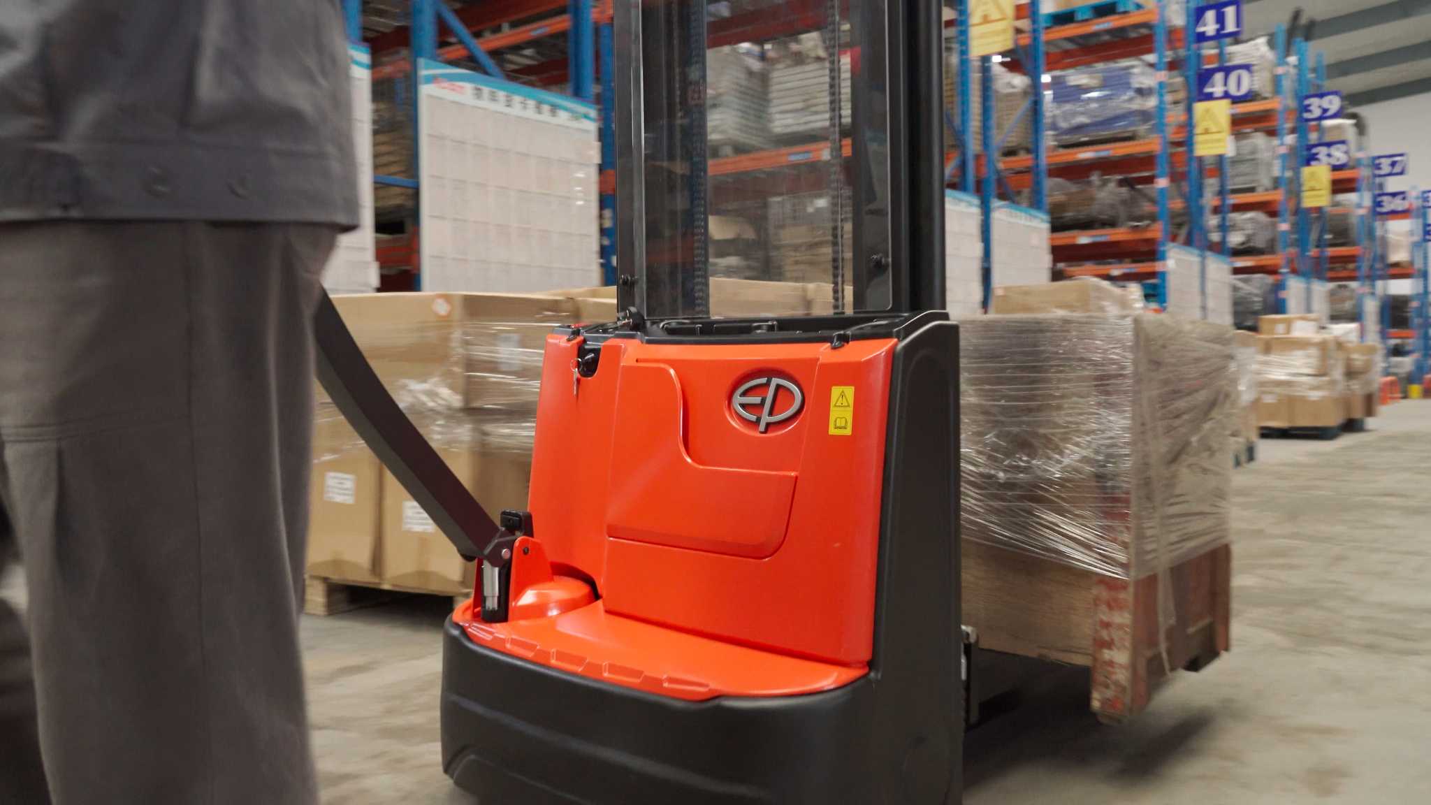 Thumbnail of EP Equipment ESA121-D electric walkie pallet stacker in warehouse operation, showing ergonomic tiller and operator control.