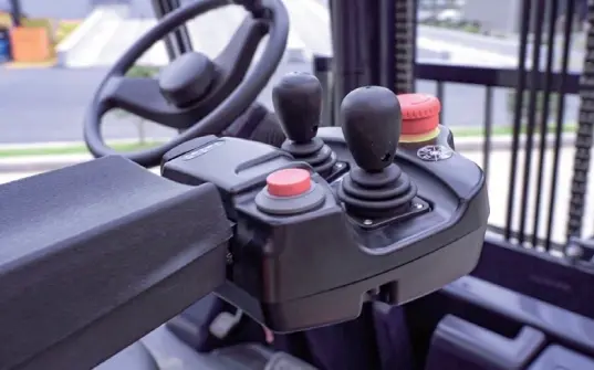 Close-up of EP Equipment CPD50L1 forklift control joystick, featuring intuitive hydraulic controls and emergency stop for enhanced operator safety.