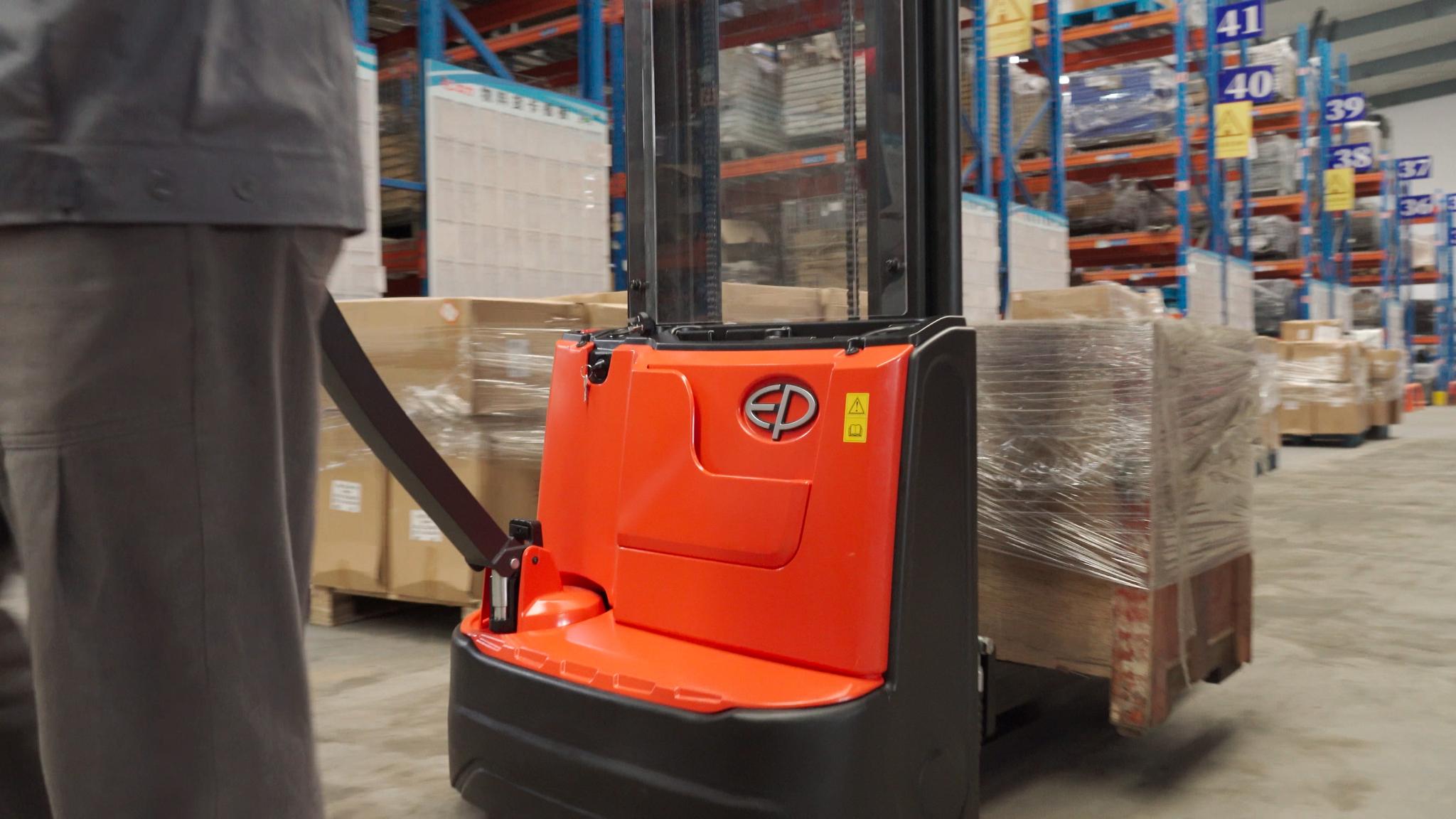 EP Equipment ESA121-D electric walkie pallet stacker in warehouse operation, showing ergonomic tiller and operator control.