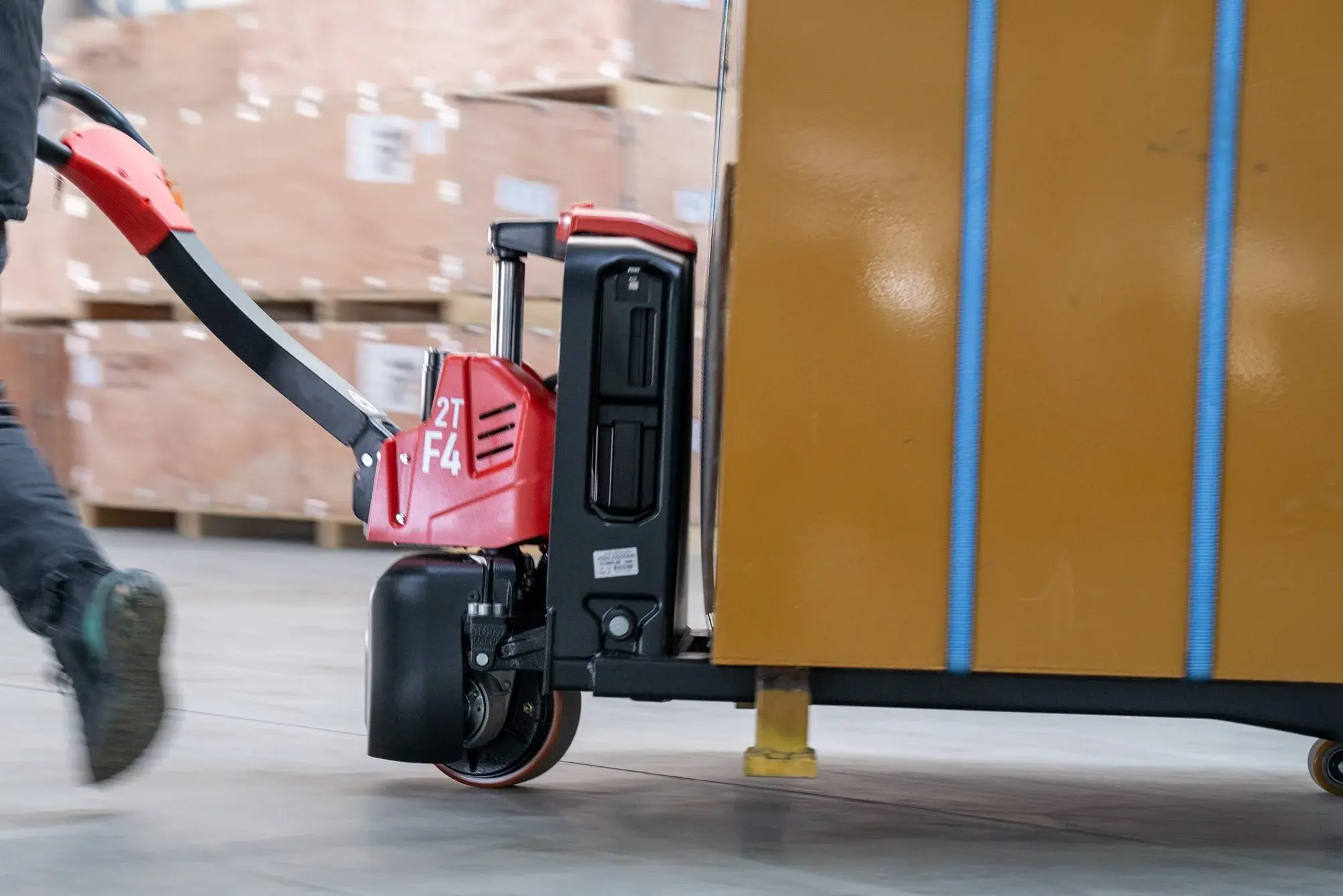 Operator using EP Equipment F4-201 electric pallet truck for material handling in warehouse.