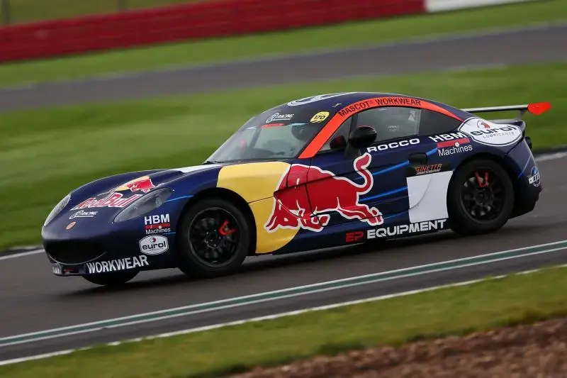Red Bull driver Rocco Coronel racing with EP-branded car at Silverstone Circuit.
