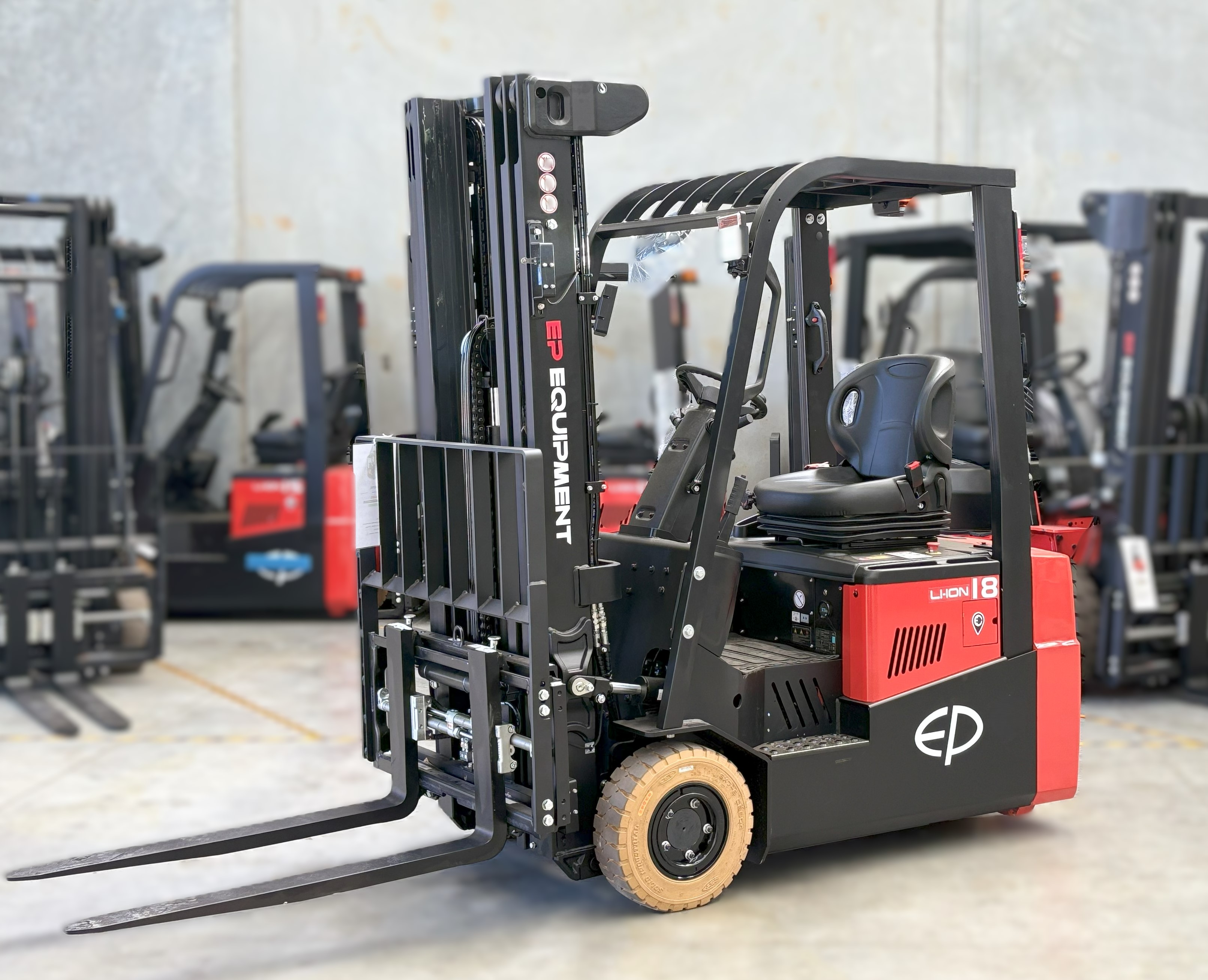 On site photo of CPD18TVL 1.8T three-wheel lithium-ion electric forklift by EP Equipment stopping in warehouse