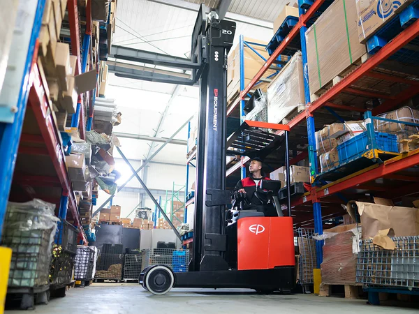 Operator using EP Equipment CQD20L 2.0T lithium-ion electric reach truck to lift pallets to upper levels in a warehouse aisle.