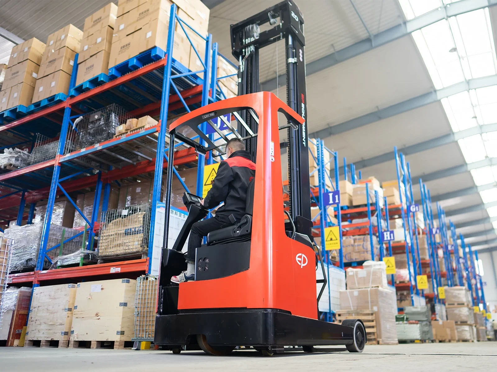 Rear view of EP Equipment CQD20L 2.0T lithium-ion electric reach truck transporting goods inside warehouse storage area.