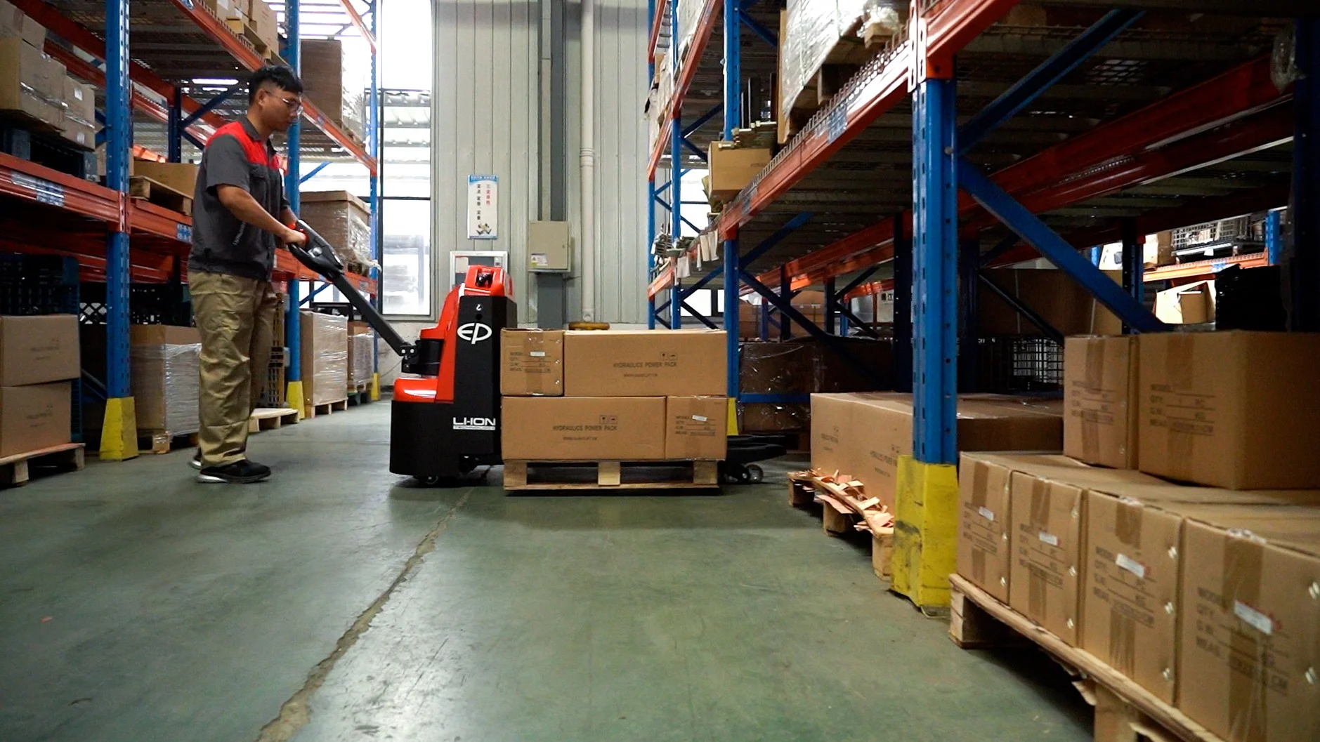Operator using EP Equipment WPL202 2.0T lithium electric pedestrian pallet truck for material handling in warehouse.